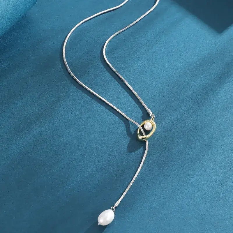 Minimalist geometric Y-shaped necklace worn by model for layering