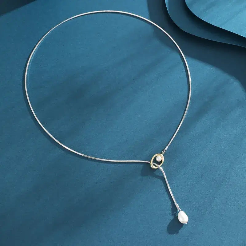 Minimalist geometric Y-shaped necklace displayed on jewelry stand