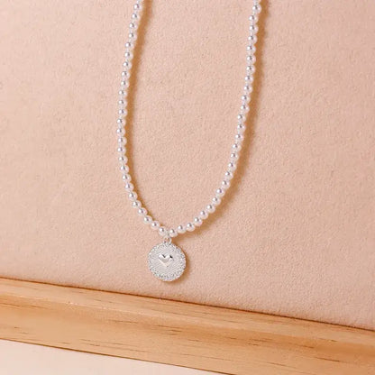 Freshwater pearl pendant necklace displayed on jewelry stand