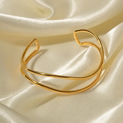 Gold-plated sea wave bangle with flowing curved design