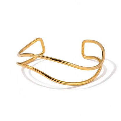 Gold-plated sea wave bangle paired with chic casual outfit