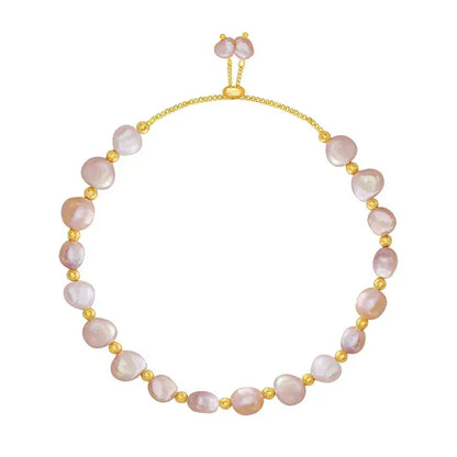 Stacked bracelets featuring freshwater pearl bracelet