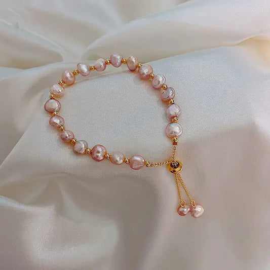 Freshwater pearl bracelet on wrist – geometric accents and delicate cable chain