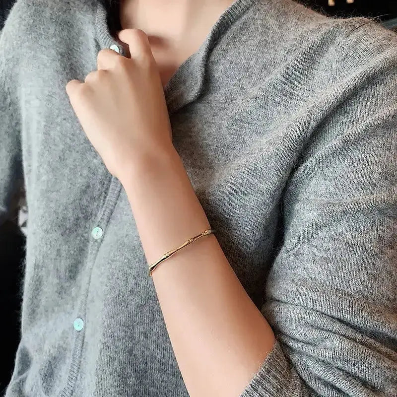 Woman wearing Simple Style Round Alloy Bangle stacked with other bracelets