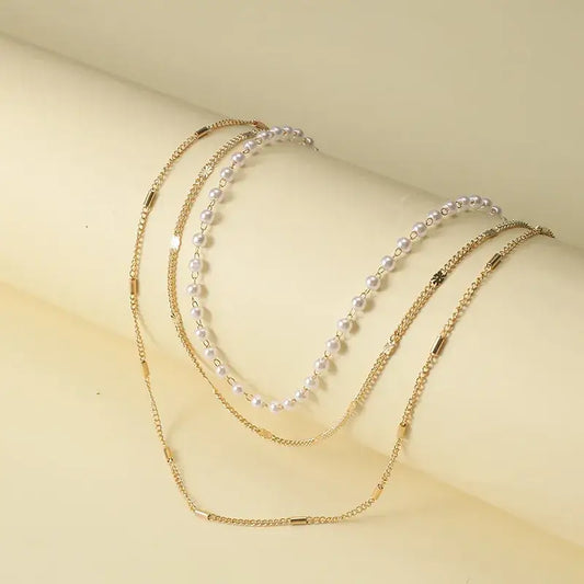 Multi-layer choker necklace with pearl accents on a model