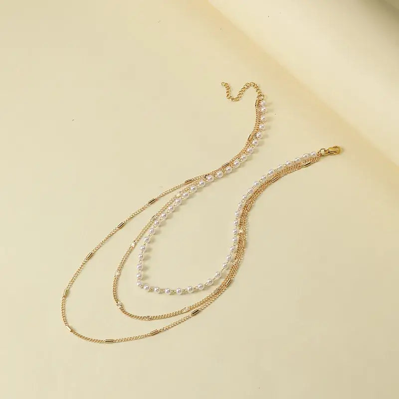 Trendy multi-layer choker necklace with layered metal chains and pearls