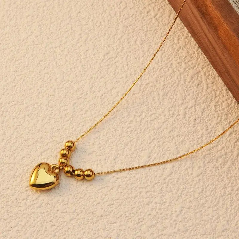 Gold heart pendant necklace worn by model for daily or date wear