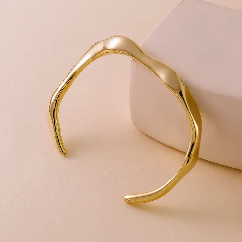 Woman wearing Gold Geometric Bracelet stacked with other bangles
