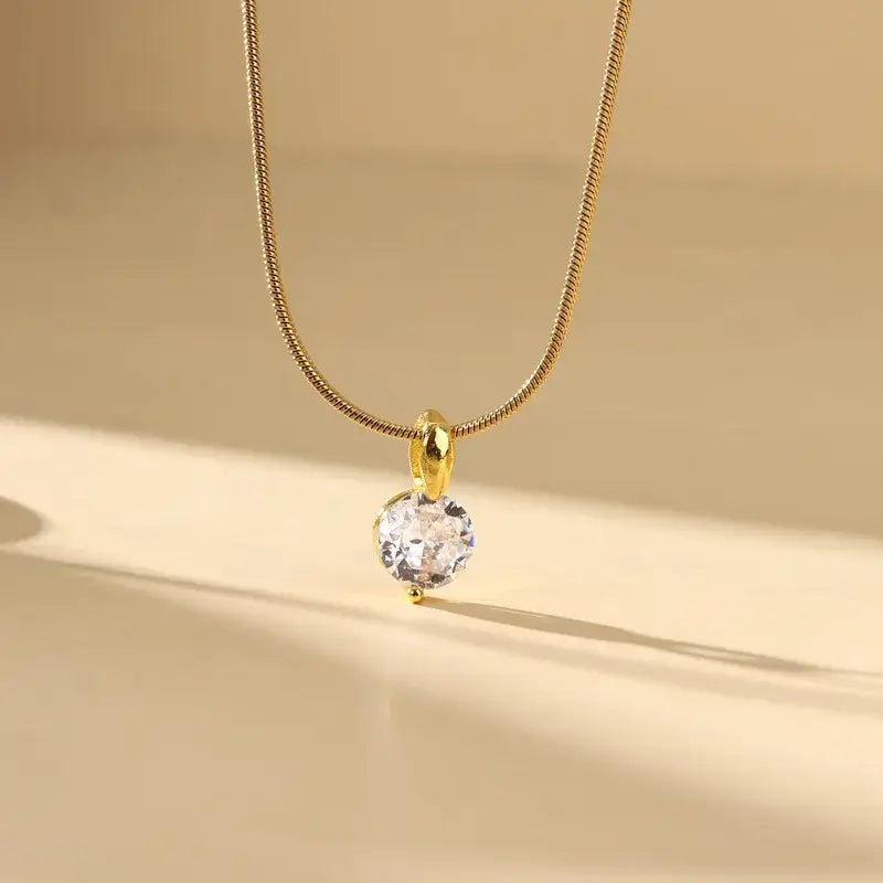 Woman wearing zircon gold-plated necklace with elegant outfit