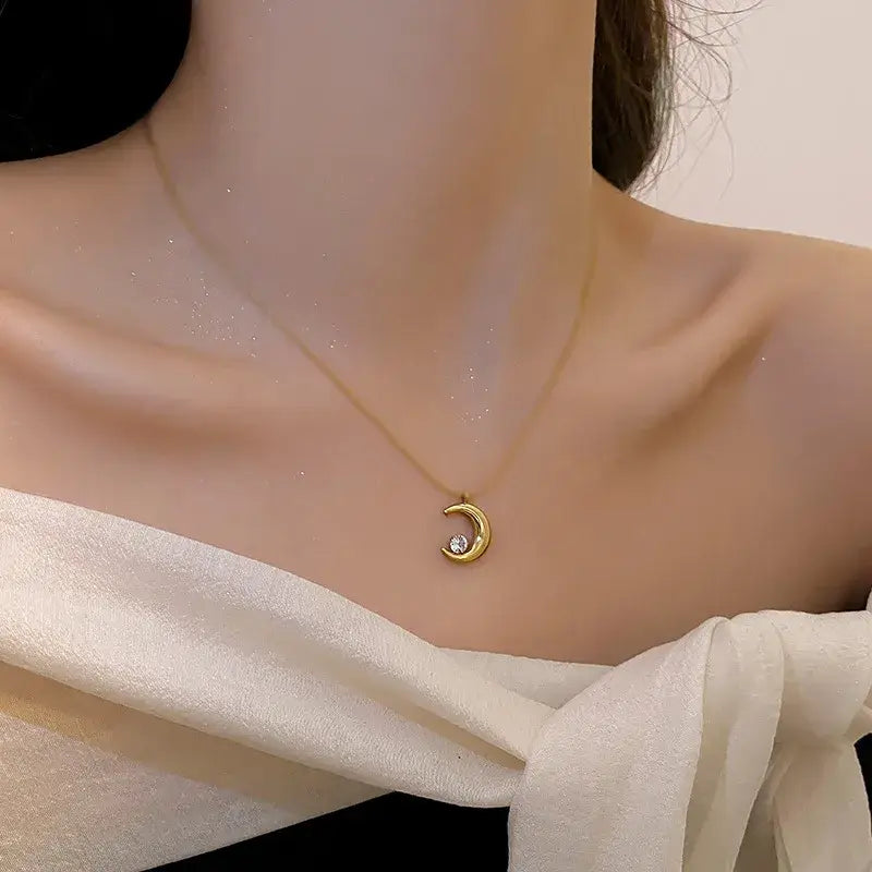Gold moon pendant necklace worn by model for everyday or tea party wear