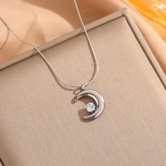 Close-up of Gold moon pendant necklace showing moon-shaped zircon pendant