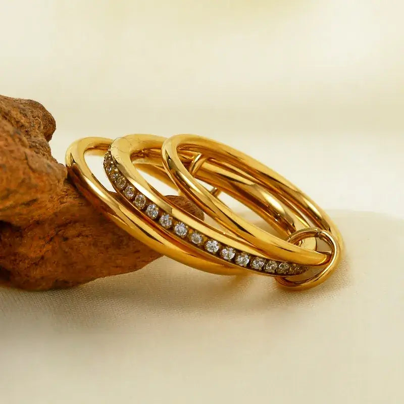 Stainless steel rings with 18K gold plating on white background