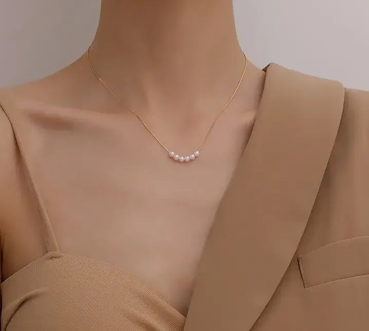 Model wearing titanium steel pendant necklace with elegant dress