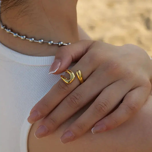 Close-up of 18K gold plated stainless steel open ring with irregular design