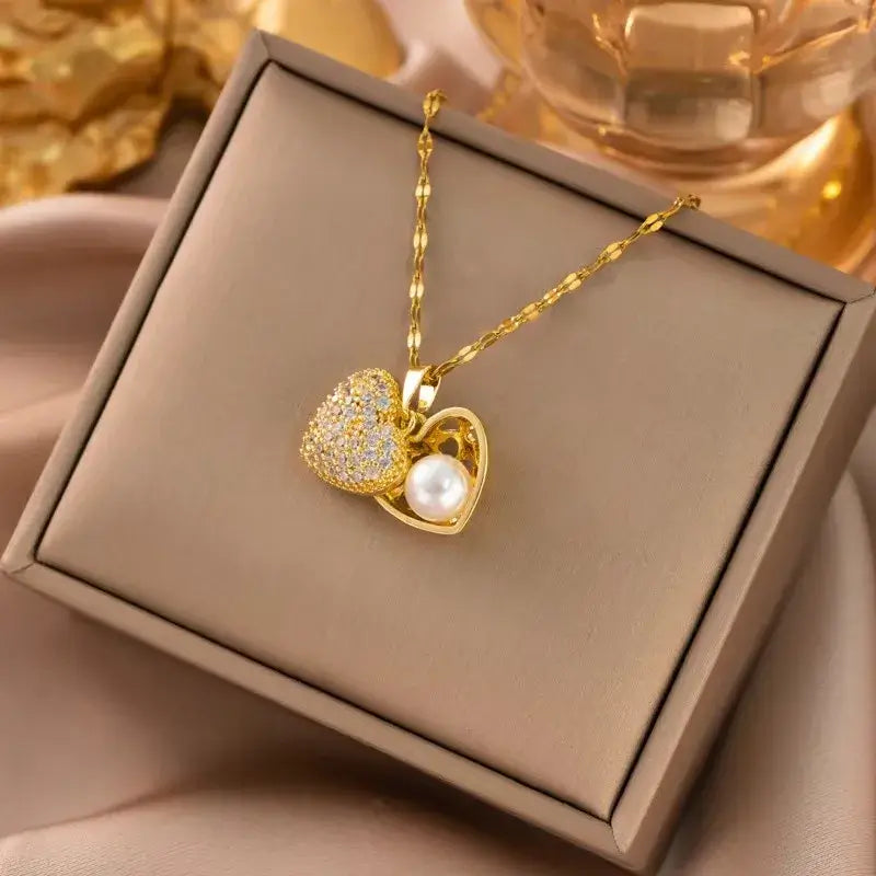 Gold heart pendant necklace with acrylic charm displayed on jewelry stand