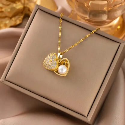 Gold heart pendant necklace with acrylic charm displayed on jewelry stand