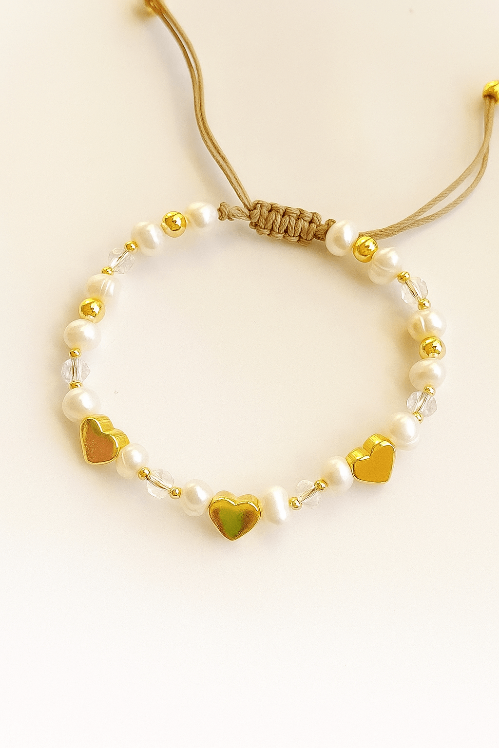Woman wearing heart charm bracelet with stylish outfit