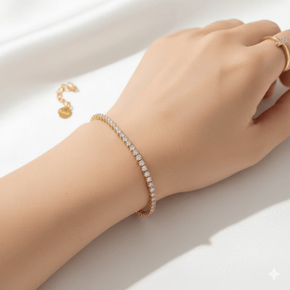 Gold plated stainless steel bracelet worn on a woman's wrist, featuring a heart-shaped chain and sparkling zircon inlay.