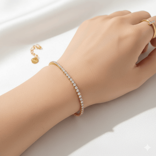Gold plated stainless steel bracelet worn on a woman's wrist, featuring a heart-shaped chain and sparkling zircon inlay.