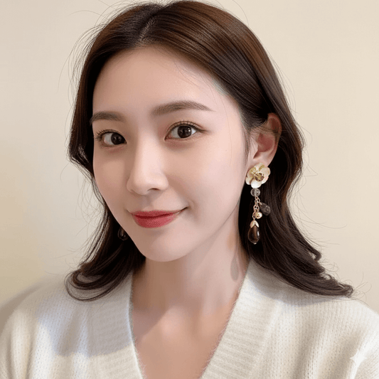 Heart Bow Knot Earrings – Geometric Pearl & Zircon Design worn by a model with subtle makeup and a white sweater.