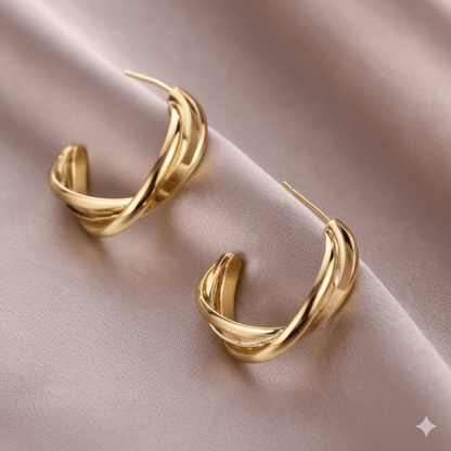 Twisted stud earrings featuring a chic spiral design on a soft satin background, perfect for minimalist jewelry lovers.