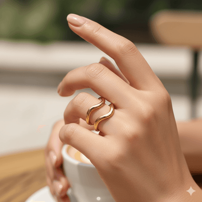 Gold plated geometric open ring worn on a hand with coffee cup, showcasing modern jewelry style.