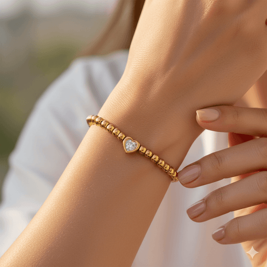 16K gold plated heart bracelet worn on a woman's wrist, showcasing elegant design and sparkling zircon inlay.