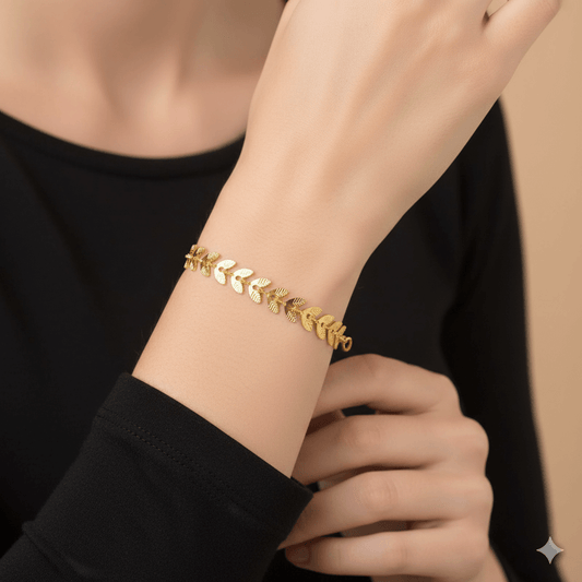 18K gold plated leaf bracelet worn on a woman's wrist, showcasing its elegant leaf design.