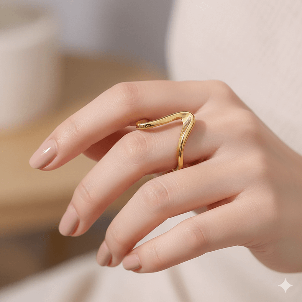 Gold plated geometric ring for women worn on a hand showing a chic and modern design.