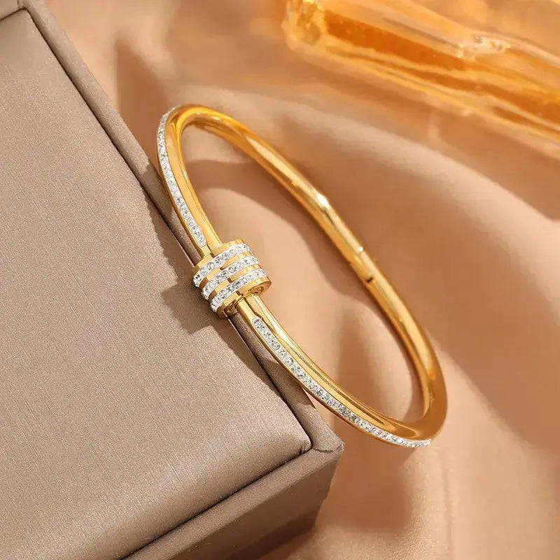 Close-up of Simple Round Titanium Steel Bangle showing 18K gold plating